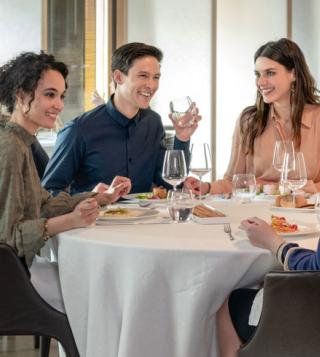 Friends at Dinner Drinking Acqua Panna Water