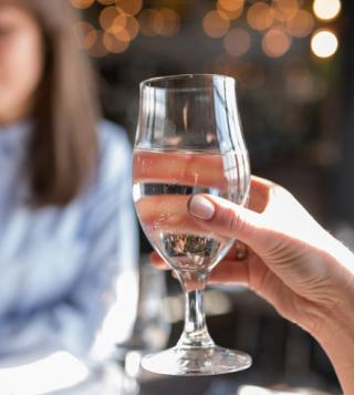 Girl Tasting Water in Glass