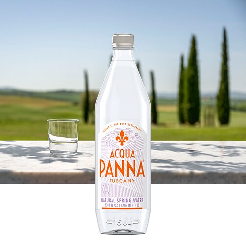 green tuscan hills with 1 liter acqua panna water bottle