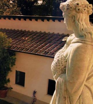 italian statue overlooking villa panna in tuscany