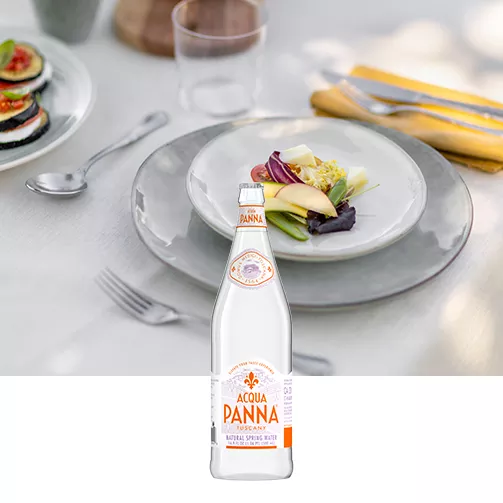 friends dining at outdoor table with 500 ml glass water bottle