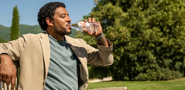 man drinks Acqua Panna in Tuscany